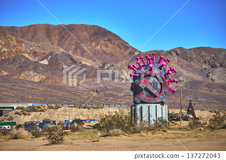 Virus Sculpture with Crossed Out Hammer and Sickle in Desert Liberty Park California Virus Sculpture with Crossed Out Hammer and Sickle in Desert Liberty Park California 137272043