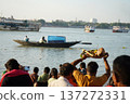 Hindu devotee holding traditional prayer offerings on a bamboo tray over his head during Chhath Puja festival at the river bank 137272331