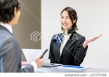 Receptionist guiding customers 137272398