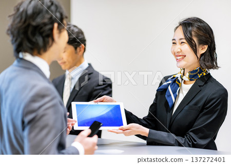 Receptionist guiding customers Receptionist guiding customers 137272401