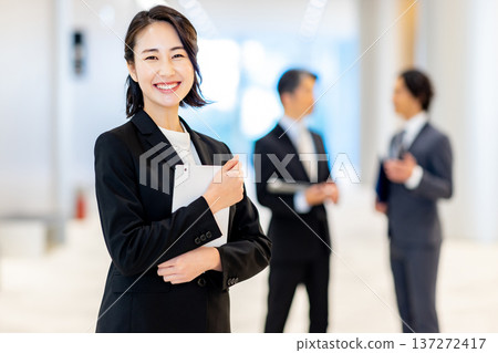 Smiling businesswoman holding a tablet Smiling businesswoman holding a tablet 137272417