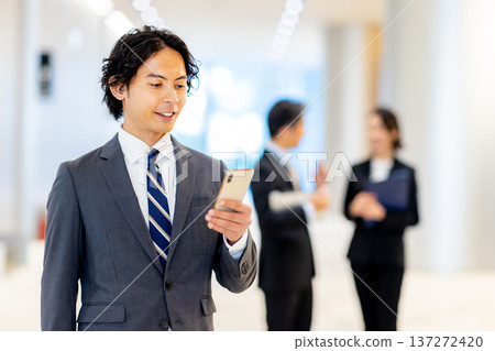 A businessman with a smartphone in the office 137272420