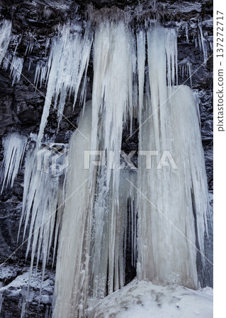 Frozen Mountain Waterfalls in Serene Winter Landscape 137272717