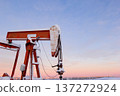 Snow Covered Oil Pumpjack at Winter Sunrise 137272924