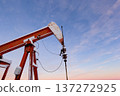 Oil Pumpjack's horsehead against blue and pink sky. 137272925