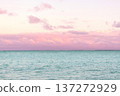 Tropical sunset with pink cloudy sky and peaceful water. 137272929