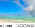 Beautiful rainbow in the cloudy sky over the ocean waters in tropics. 137272932