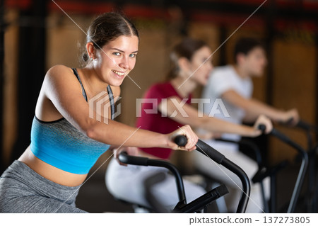 Woman in the top is engaged in an airbike Woman in the top is engaged in an airbike 137273805
