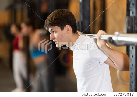 Man with a barbell in the hall Man with a barbell in the hall 137273818
