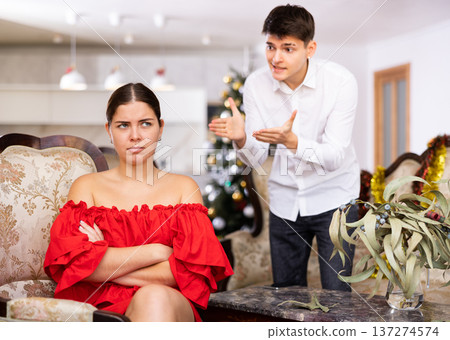 Couple quarreling - husband expresses displeasure to wife during new year celebration Couple quarreling - husband expresses displeasure to wife during new year celebration 137274574