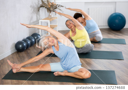 Mature lady performs pose Parivritta janu shirshasana Mature lady performs pose Parivritta janu shirshasana 137274688
