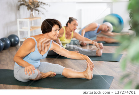 Group of elderly woman doing yoga on mat in studio 137274701