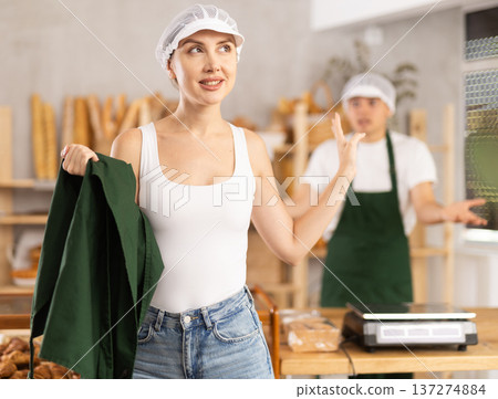 In bakery, confused female employee during quarrel with guy boss In bakery, confused female employee during quarrel with guy boss 137274884