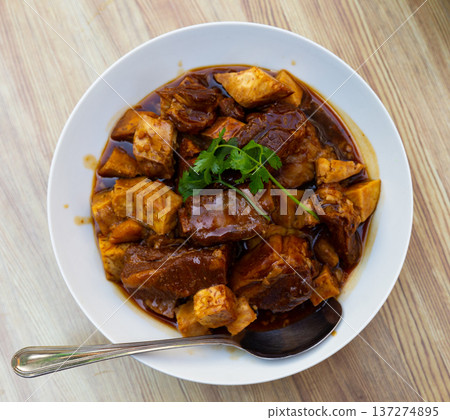 Pork ribs cooked in Chinese style with taro root vegetable and red wine or soy sauce Pork ribs cooked in Chinese style with taro root vegetable and red wine or soy sauce 137274895