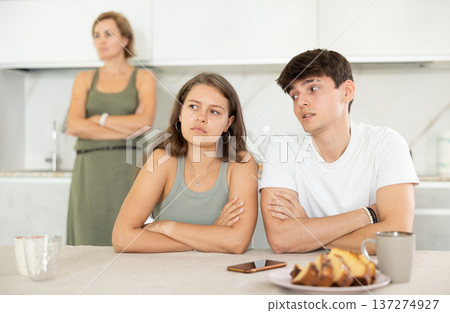 Mom make claims to couple in home kitchen Mom make claims to couple in home kitchen 137274927