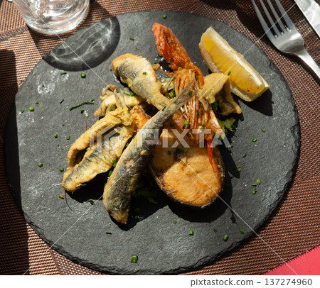 Grilled seafood and fish are specialty at coastal restaurant Grilled seafood and fish are specialty at coastal restaurant 137274960