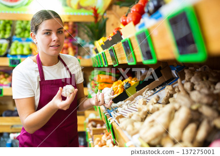 Portrait of a young saleswoman working in a vegetable store Portrait of a young saleswoman working in a vegetable store 137275001