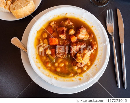 Soup is made from potatoes, carrots, and legumes, topped with bacon and chunks of tender beef Soup is made from potatoes, carrots, and legumes, topped with bacon and chunks of tender beef 137275043
