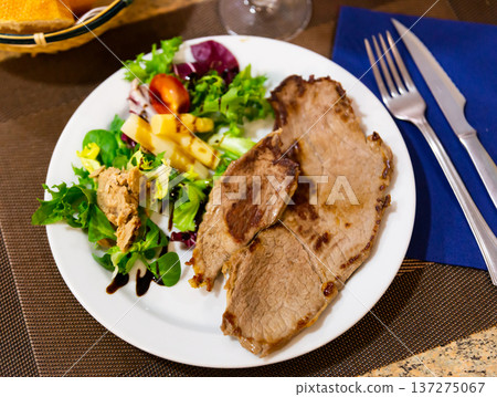 Tender beef steak garnished with fresh vegetable salad Tender beef steak garnished with fresh vegetable salad 137275067