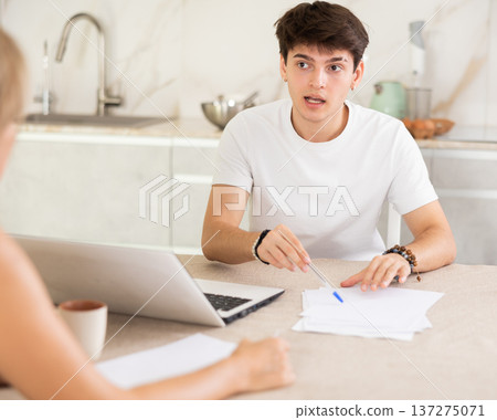 An insurance agent tells young guy the terms of property and life insurance 137275071