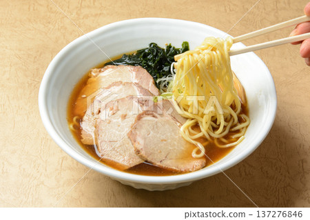 Soy sauce ramen picked up with chopsticks 137276846