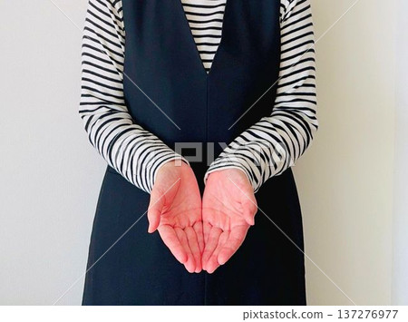 A woman holding out both hands 137276977