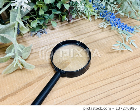 A magnifying glass placed on a wooden desk A magnifying glass placed on a wooden desk 137276986