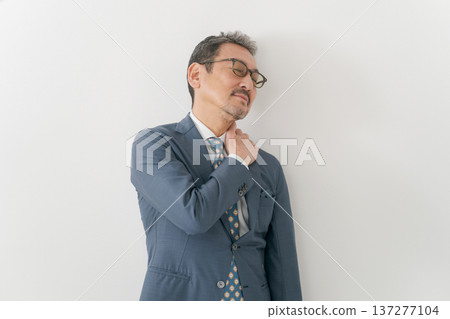 Business person suffering from stiff shoulder 137277104