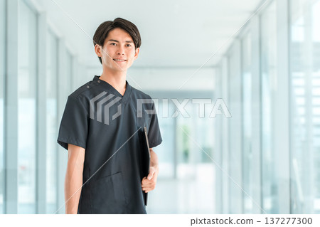 Young Asian men wearing scrubs, doctors, nurses, caregivers, and emergency physicians Young Asian men wearing scrubs, doctors, nurses, caregivers, and emergency physicians 137277300