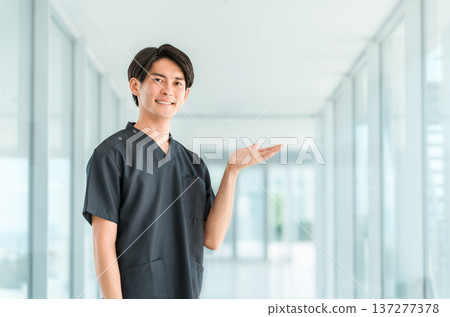 Young Asian male doctor, nurse, caregiver, and emergency physician wearing scrubs Young Asian male doctor, nurse, caregiver, and emergency physician wearing scrubs 137277378