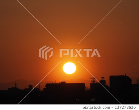 Orange evening sky and the sun setting over the Kanto Mountains Orange evening sky and the sun setting over the Kanto Mountains 137278620