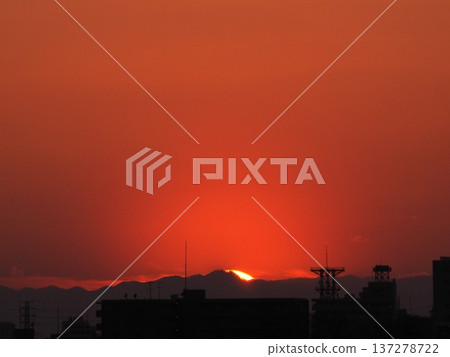 Orange evening sky and the sun setting over the Kanto Mountains Orange evening sky and the sun setting over the Kanto Mountains 137278722