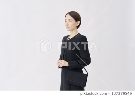 Portrait of a woman in mourning clothes on a white background Portrait of a woman in mourning clothes on a white background 137279549