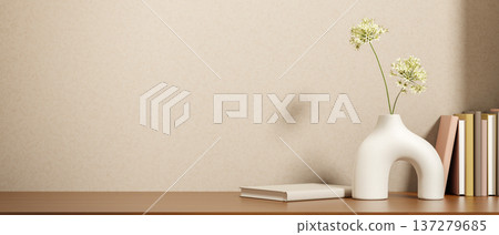 Unique design flower vase and books on wooden counter table with sunlight shining on beige loft wall Unique design flower vase and books on wooden counter table with sunlight shining on beige loft wall 137279685