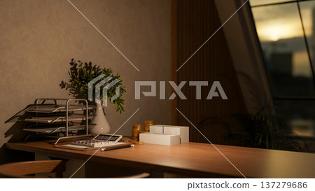 Calculator aside paper rack with banknote and gold coin on wooden table across window in office room Calculator aside paper rack with banknote and gold coin on wooden table across window in office room 137279686
