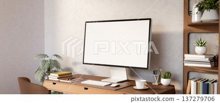 White screen computer and coffee on wooden table aside bookshelf and houseplant in plain wall room. White screen computer and coffee on wooden table aside bookshelf and houseplant in plain wall room. 137279706