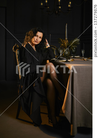 Sitting at a table with candles in a dark room during a gathering 137279876