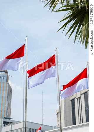 Indonesian flag hoisted under a blue sky / Red and white flag symbolizing the nation 137279909