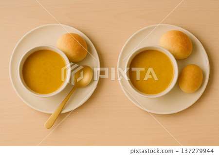 清晨的寧靜景象，一碗金黃色的濃湯配上鬆軟的麵包。 137279944