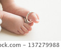 Newborn baby's feet with wedding ring on the thumb, Newborn photo 137279988
