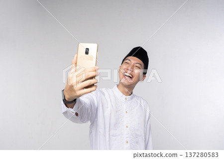 Person wearing cultural clothing takes enthusiastic social media picture Person wearing cultural clothing takes enthusiastic social media picture 137280583