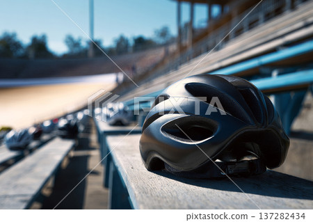 aerodynamic helmet positioned on cycling track stadium seats, sports equipment concept, bright 137282434