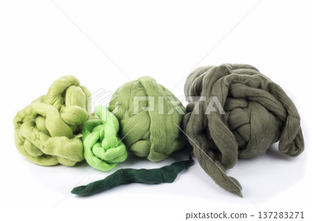 Skeins of natural merino wool on a white background Skeins of natural merino wool on a white background 137283271