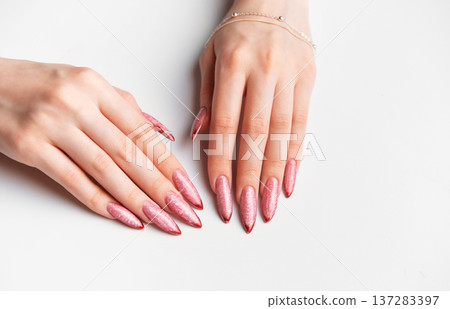 Woman hands manicure with long glittery rose gold nails 137283397