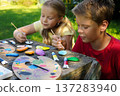 Guided by imagination, children decorate natural stones, creating joyful handmade gifts full of their creativity. 137283940