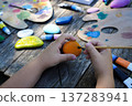 Colorful paint transforms simple stones into playful scenes, crafted by childrens hands into personalized presents. 137283941