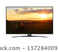 Flat screen TV with rural landscape with straw roll and sunset sky on screen 137284009