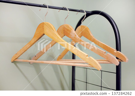 Wooden clothers hangers on rack Wooden clothers hangers on rack 137284262