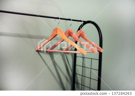 Wooden clothers hangers on rack Wooden clothers hangers on rack 137284263