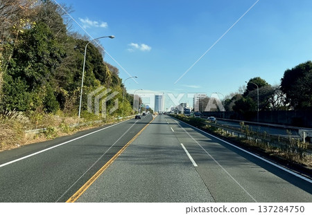 Straight road leading to the city Blue sky main road scenery 137284750